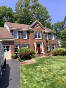 image shows the front exterior of a brick-faced house