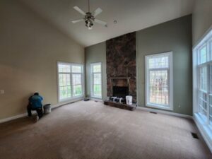 image shows the interior of a spacious living room featuring a neutral color palette